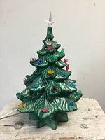 Front view of ceramic Christmas tree with star topper and lights