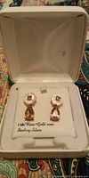 Open jewelry box showing the pair of rose gold over sterling silver drop earrings with pink stones