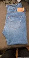 Folded Levi's 501 blue jeans showing rear pocket, red tab and leather patch