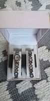 Coach watch and bracelet set displayed inside open presentation box