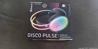 Front of retail box showing TRAXX Disco Pulse wireless headphones artwork and Bluetooth logo