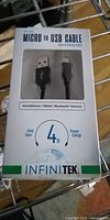 Front of sealed INFINITEK retail box showing Micro-USB to USB-A cable, length 4 ft