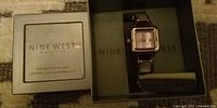 Nine West wristwatch inside branded box with instructions card visible