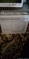 Front view of boxed SANSI LED UV Sterilizer Box on shelf