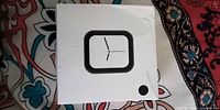 Front of unopened smartwatch box showing square watch graphic