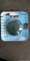 Front of retail package showing turquoise Bluetooth shower speaker and printed specifications
