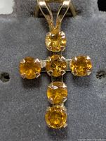 Front view of 10K gold cross pendant with six citrines