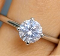 Close-up of round moissanite in prong setting on band