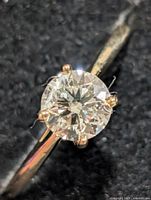 Close-up of round brilliant lab diamond in six-prong yellow gold setting