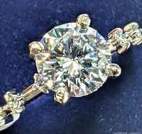 Four-prong round brilliant lab diamond solitaire on white gold band with accents