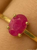 Close-up of ruby stone and prong setting on gold ring