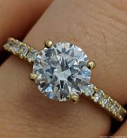 Ring on finger showing center stone and accent stones