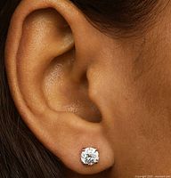 Diamond stud earring shown on ear for scale and appearance