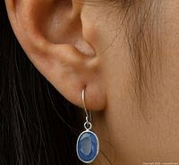 Earring worn on ear showing size and drop style