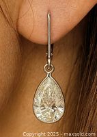 Earring worn, showing size, shape, and setting