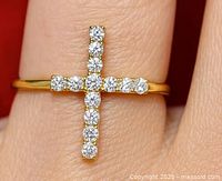 Ring on finger showing cross diamond design