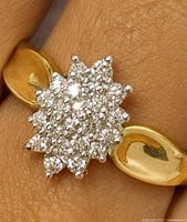 Close-up showing diamond cluster and gold band