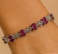 Ruby and silver bracelet worn on wrist
