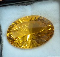 Top view of oval faceted citrine gemstone in foam display