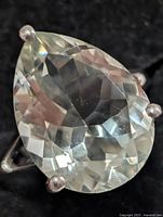 Top view showing pear-cut green amethyst in prong setting