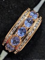 Angled view showing tanzanite row and accent stones