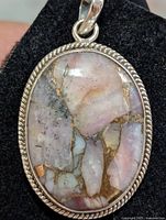 Front view of sterling silver pendant with oval pink Mojave turquoise stone