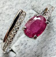 Top view of silver ring showing ruby and accent stones