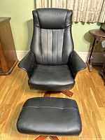 front view of chair and ottoman showing upholstery and base