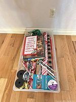 Top view of tote showing wrapping paper rolls, gift bags, ribbon spools and twine