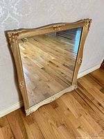 Full view of mirror standing against wall