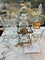Full set showing both decanters in stand, cordial glasses, champagne bucket and loose stopper