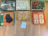 All six jigsaw puzzle boxes laid out