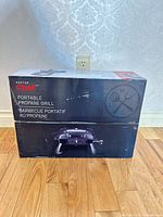 Front of sealed box showing Master Chef portable propane grill branding