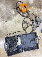 All tools laid out on floor showing cords and cases