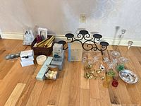 Group shot showing entire mixed candle lot with candelabra, tapers, tealights, glass holders and accessories on floor