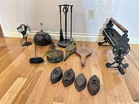 Front view showing entire lot of irons, kettle, bellows, tool set, log roller, incense burner and stove fan