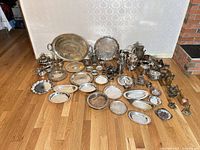 Entire lot laid out showing variety of silverplate and brass items
