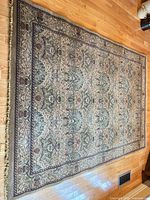 Full view of entire rug laid flat on hardwood floor