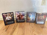 Front view of four DVD box sets aligned on floor