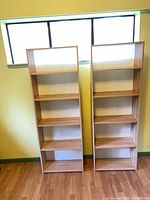 Front view of both bookcases showing overall design and shelves.