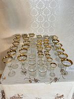Front view of entire set showing variety of glass types and gold rims