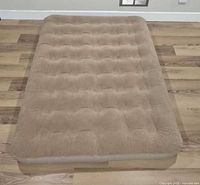 Top view of tan Coleman inflatable air mattress
