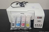 Printer front with sealed ink bottle pack and power cord