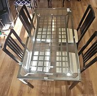 Top-down view of glass dining table with four chairs