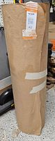 Full view of kraft paper roll standing upright