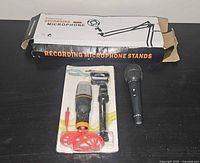 Overview of boxed boom arm, condenser mic kit, and handheld mic