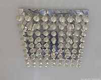 Flush-mount light unlit, full view of chrome base and glass drops