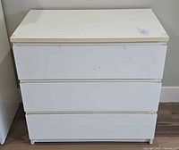 Front view of white 3-drawer dresser chest