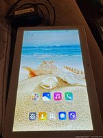 Tablet powered on displaying home screen