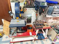 Band saw, drill press, drill bits on stand